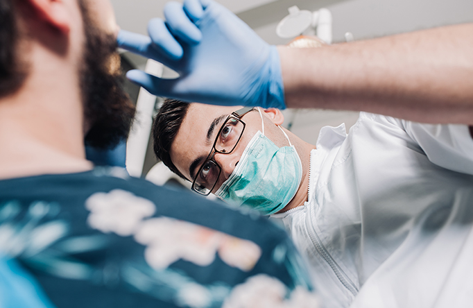 dentist looking in patients mouth