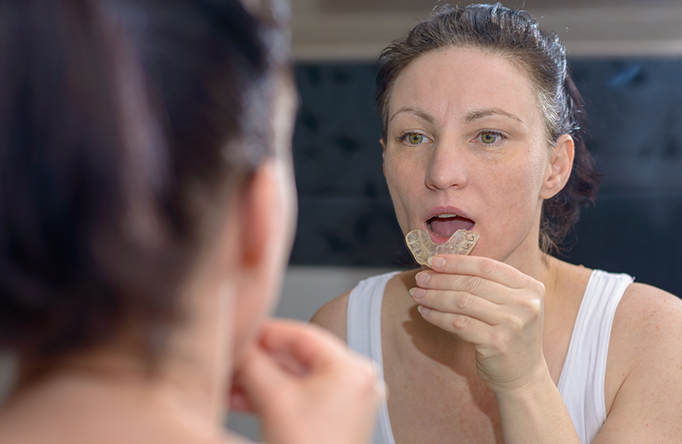 Lady putting Gum Shield in mouth