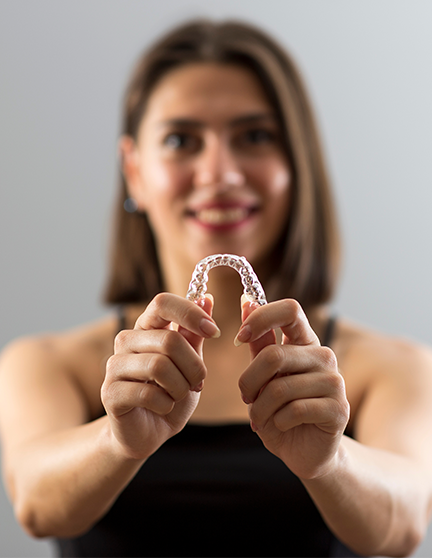 Lady with Invisalign aligner
