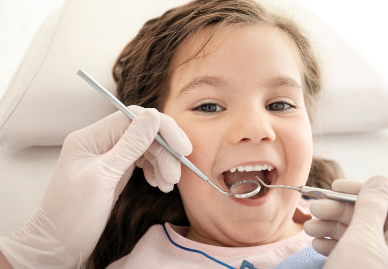 child having dental check up smiling