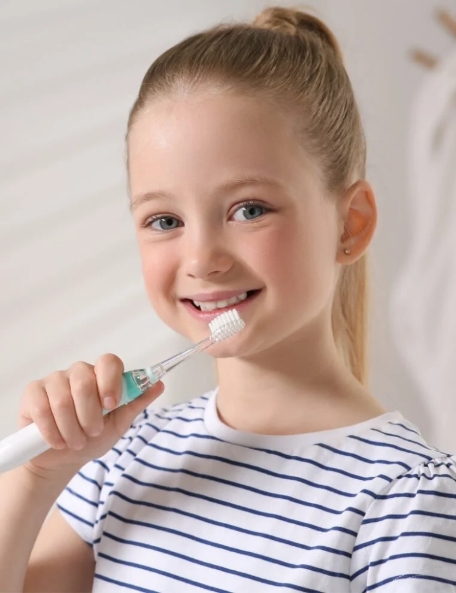 Young girl brushing her teeth