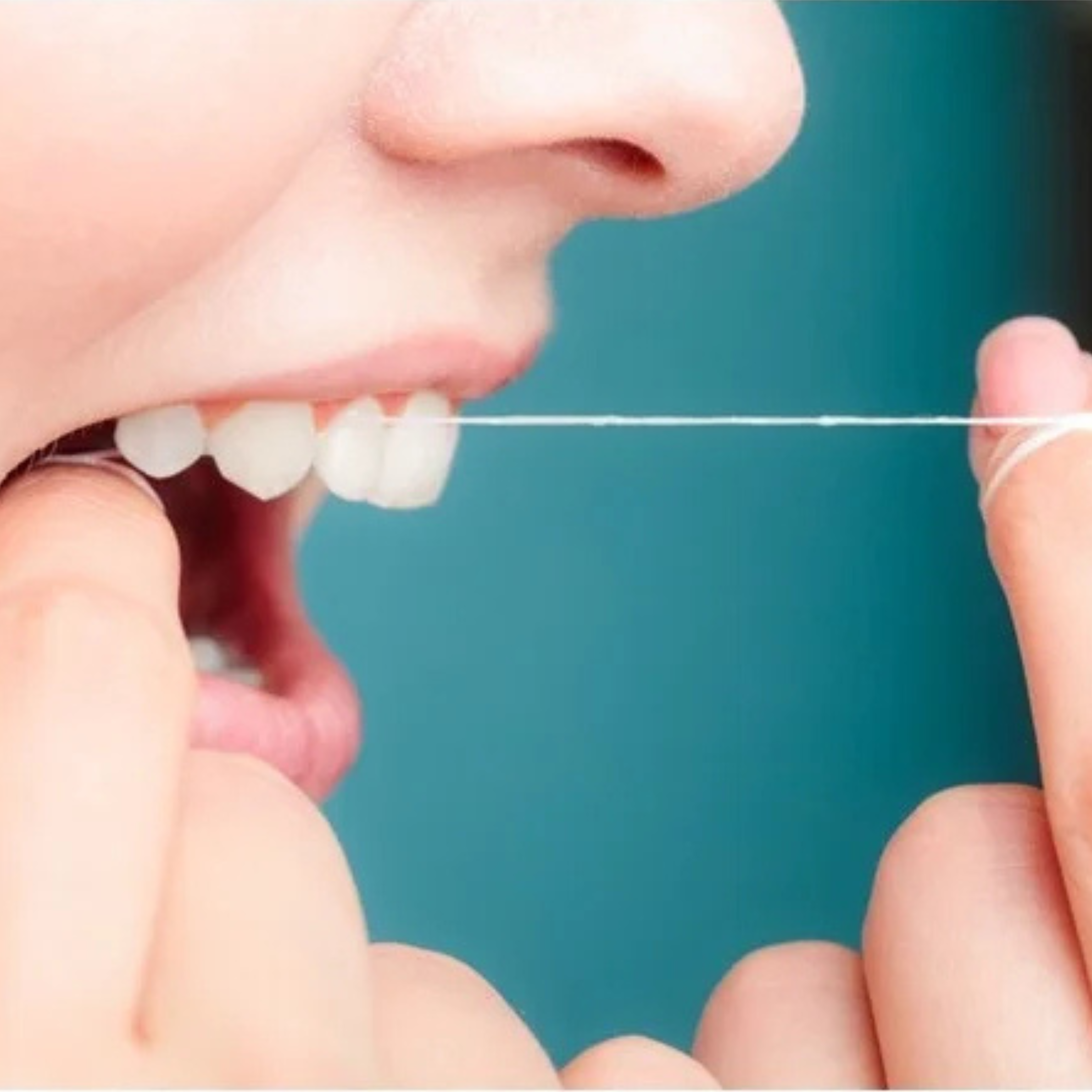 Lady flossing her teeth