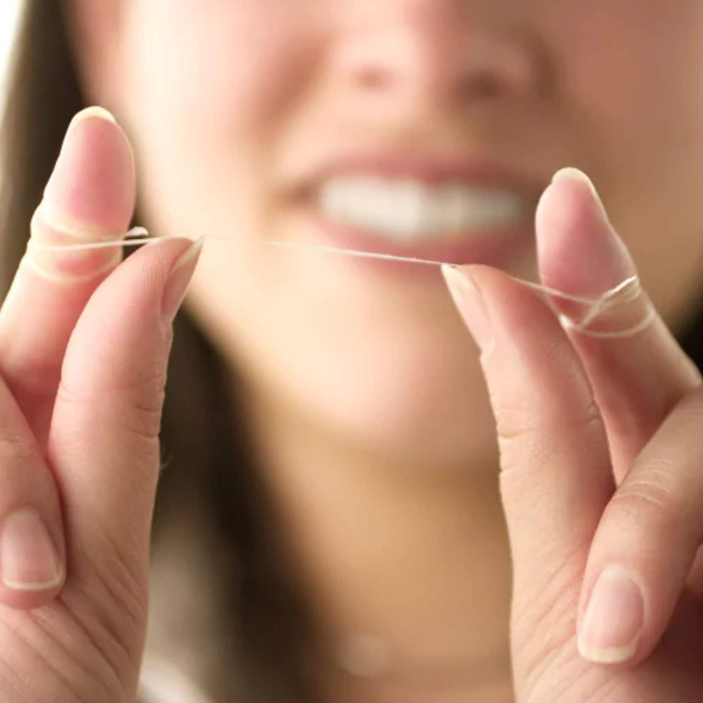 Dental Floss wrapped around a ladies fingers